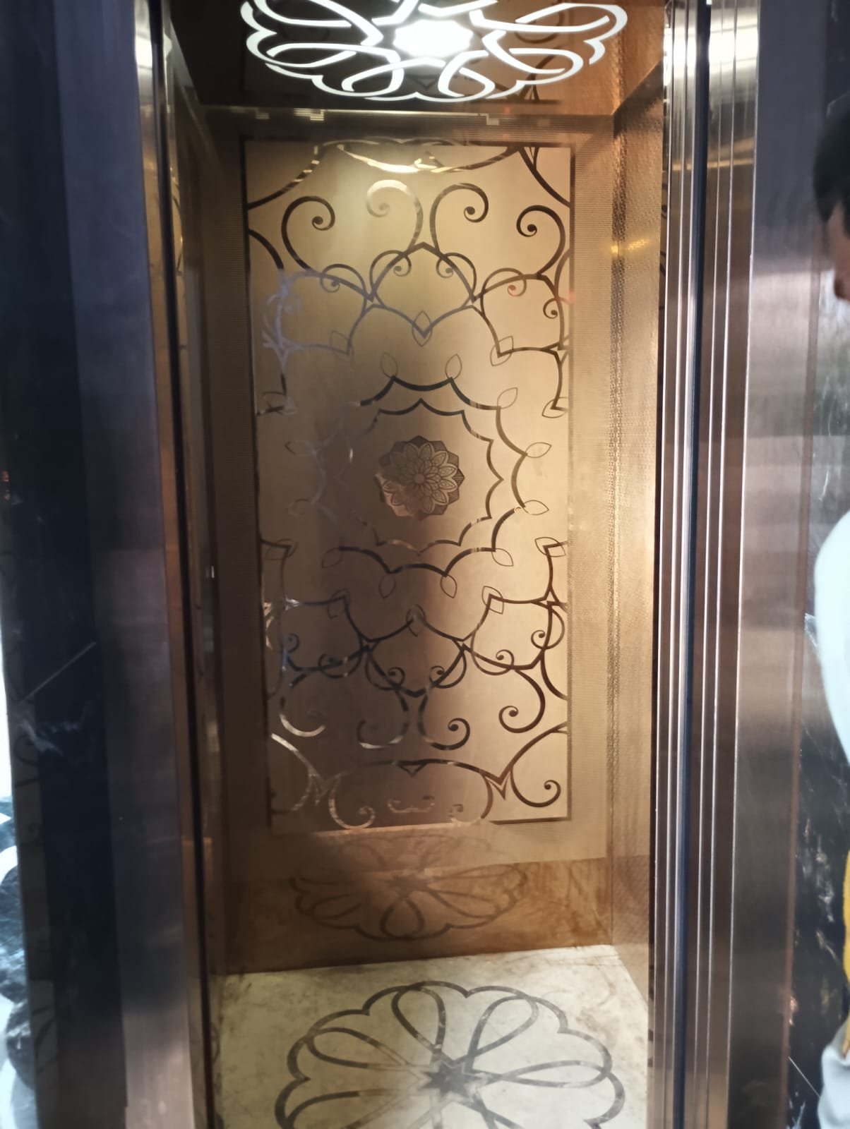 Premium passenger elevator cabin with elegant golden floral interior design